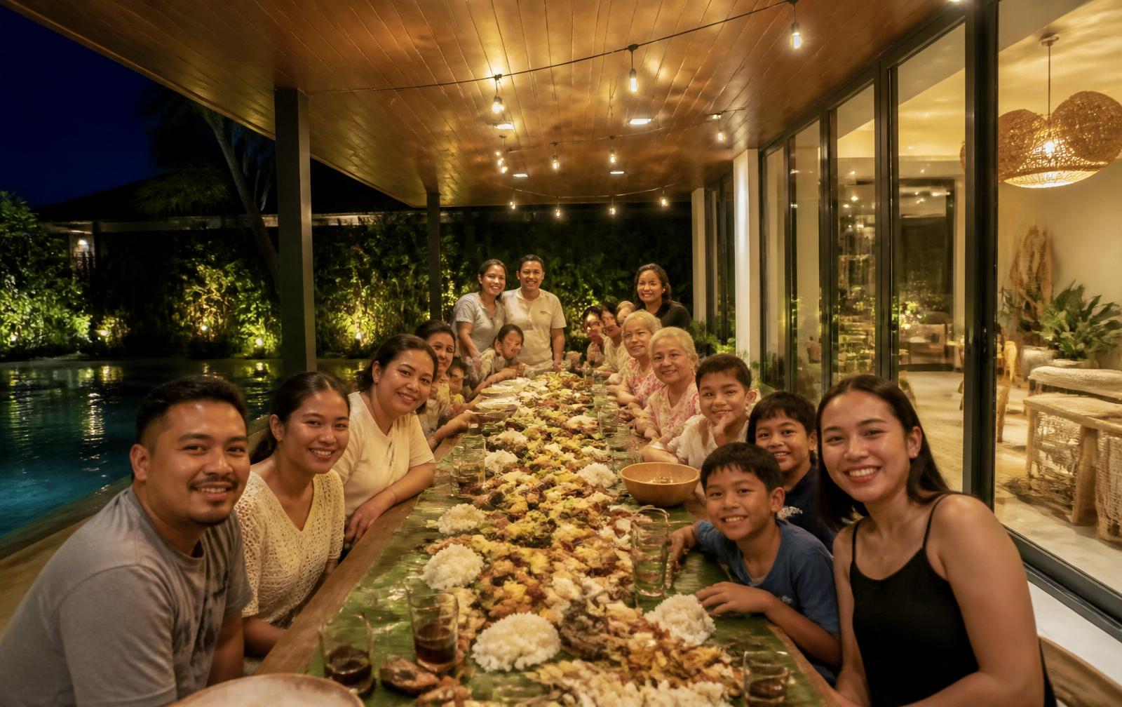 Family and friends celebrating together at a long table at a Uwina villa